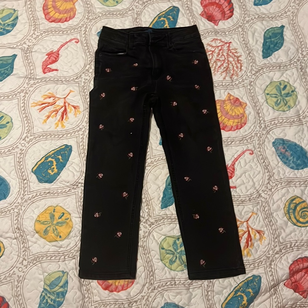 Cute jeans, with small rose prints on front. Has pockets and button.